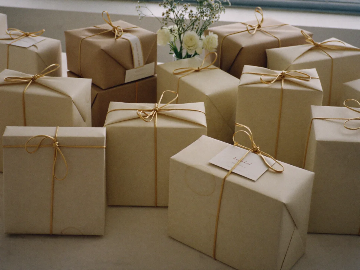 Wedding gifts wrapped in cream paper and gold ribbon
